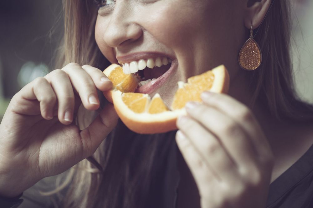 woman eating an orange